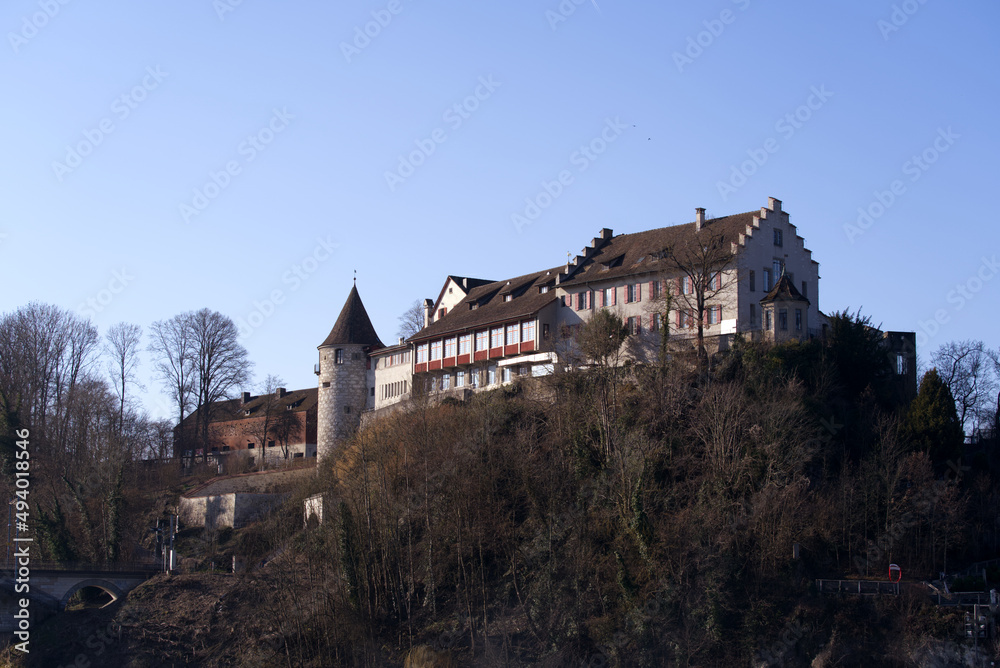 Laufen Castle on a hill above the famous Rhine Falls on a sunny spring day. Photo taken March 5th, 2022, Laufen-Uhwiesen, Switzerland.
