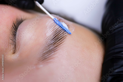 close-up of eyebrow hairs styled and combed with laminating compositions photo