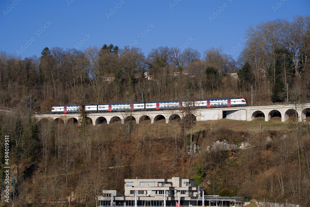 Obraz premium Railway viaduct at Neuhausen am Rheinfall on a sunny spring day near the famous Rhine Falls. Photo taken March 5th, 2022, Neuhausen am Rheinfall, Switzerland.