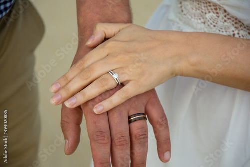 rings on the hands of the groom and the bride