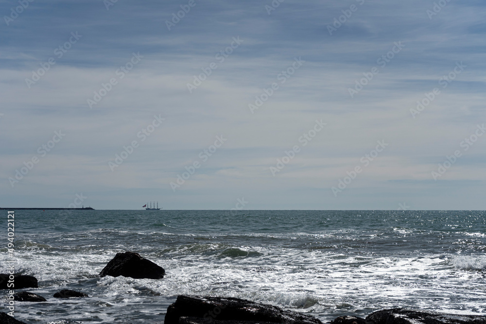 Frigate anchored near the beach