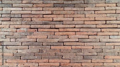 Brick wall background is a wall made of clay bricks  giving the structure strength and cement line between bricks that looks beautiful. It is popular to build a wall of ancient monuments.copy space 