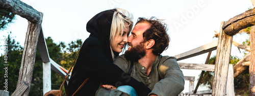 Quadro su tela Horizontal banner with romantic happy couple in love sitting on wooden stairs on