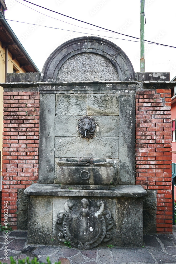 Old fountain in Nicola Fabrizi street Castelnuovo Garfagnana, Tuscany, Italy