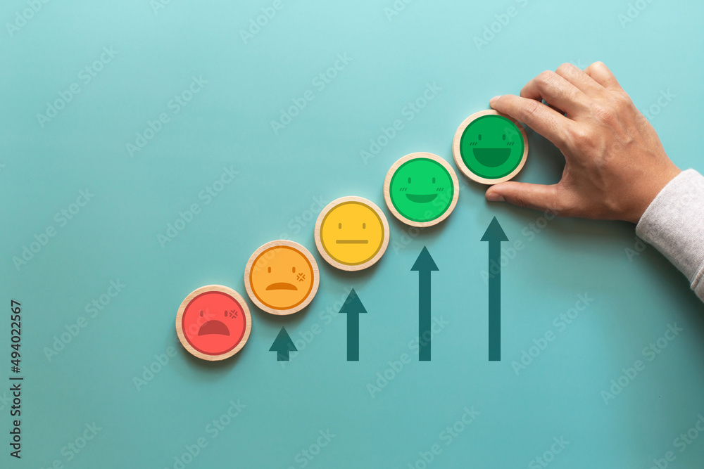 Customer giving smile emoticon and increasing arrows on green background. Service rating, Increase customer satisfaction Customer giving smile emoticon and increasing arrows on green background. Service rating, Increase customer satisfaction