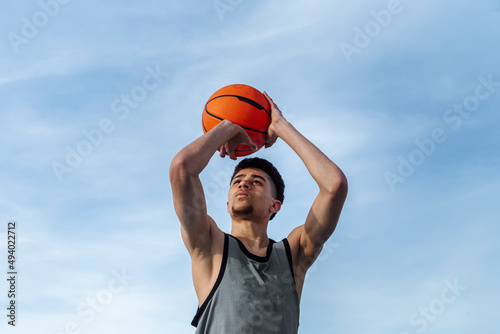 Hispanic basketball player preparing to throw ball