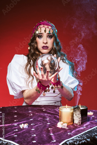 Soothsayer telling fortunes with magic ball photo