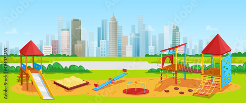 Kids playground with playing equipment on background of high-rise buildings and skyscrapers. Nature and architecture in cityscape. Urban park with place for children in modern city, downtown