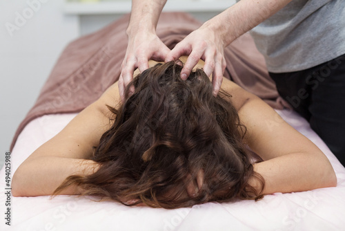 Closeup beautiful woman having deep back neck head massage. View from above