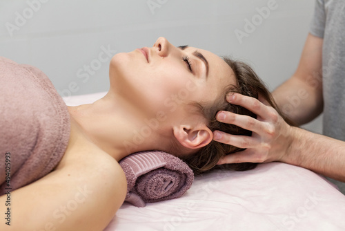 Closeup beautiful woman having deep back neck head massage. Side view