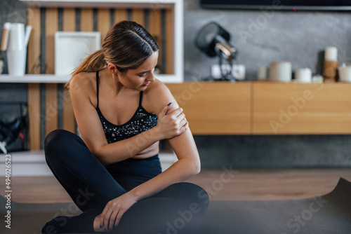 Portrait of a girl, holding her arm, stretching. © bnenin