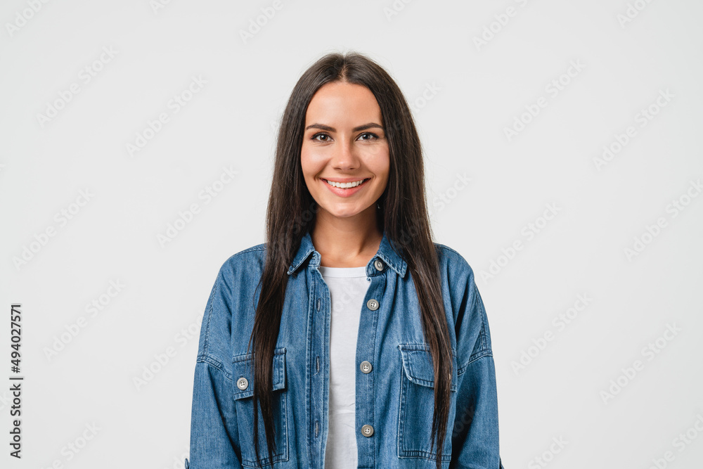 Smiling happy caucasian young woman in denim shirt looking at camera isolated in white background. Toothy smile, dentistry stomatology concept Smiling happy caucasian young woman in denim shirt looking at camera isolated in white background. Toothy smile, dentistry stomatology concept