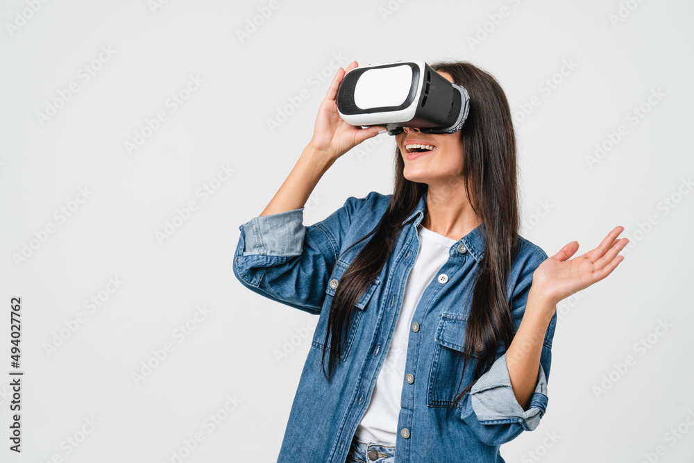 Excited amazed happy caucasian young woman girl using VR glasses, playing virtual games online, watching video isolated in white background. Technology concept Excited amazed happy caucasian young woman girl using VR glasses, playing virtual games online, watching video isolated in white background. Technology concept