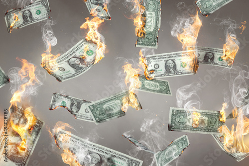 Burning US Dollar notes are falling down