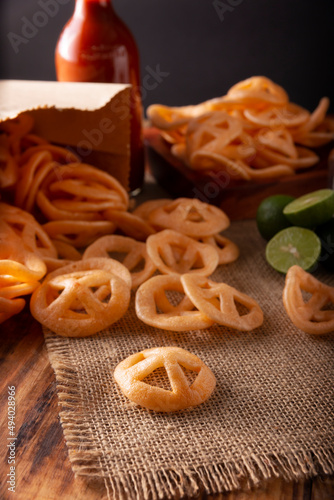 Chicharrones de Harina. Also known as duros, duritos, Mexican wagon wheels or pinwheels, they are a very popular snack made from flour, commonly accompanied with hot sauce and lemon juice. photo