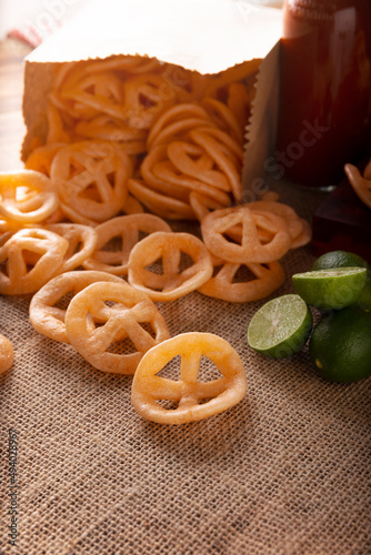 Chicharrones de Harina. Also known as duros, duritos, Mexican wagon wheels or pinwheels, they are a very popular snack made from flour, commonly accompanied with hot sauce and lemon juice. photo