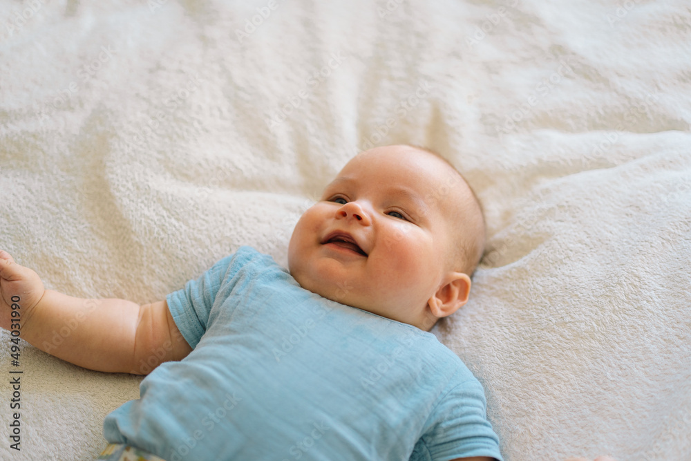 Cute newborn little baby boy in bed. Baby goods packaging template. Healthy child, concept of hospital and happy motherhood. Infant baby. Cute newborn little baby boy in bed. Baby goods packaging template. Healthy child, concept of hospital and happy motherhood. Infant baby.