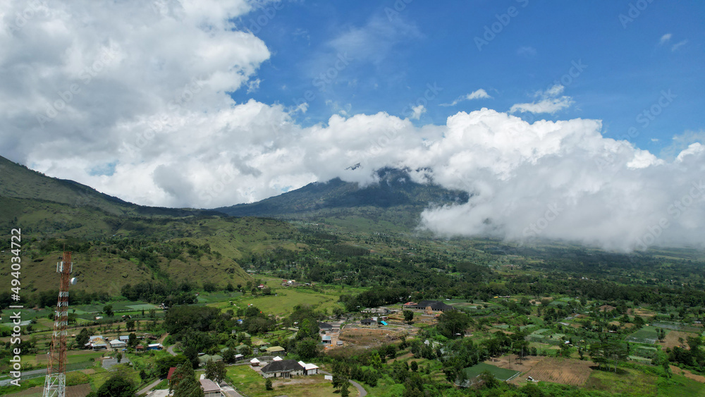 Aerial view of some agricultural fields in Sembalun. Sembalun is situated on the slope of mount Rinjani and is surrounded by beautiful green mountains. Lombok, Indonesia, March 22, 2022