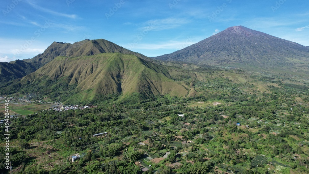 Aerial view of some agricultural fields in Sembalun. Sembalun is situated on the slope of mount Rinjani and is surrounded by beautiful green mountains. Lombok, Indonesia, March 22, 2022