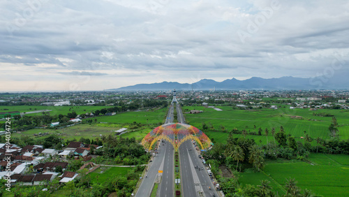 Aerial view of the city colorful Monument Tembolak Rainbow and Mataram City metro monument. The newest icon from the city of Mataram Indonesia. Lombok, Indonesia, March 22, 2022 photo