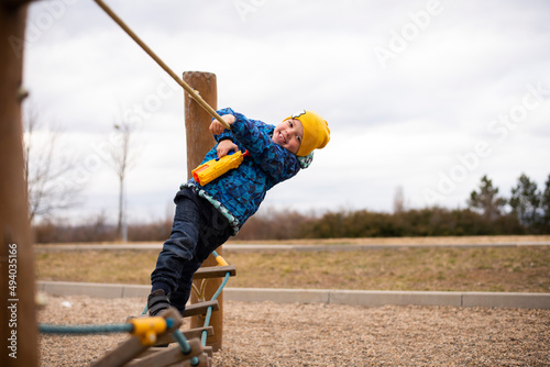 A cute 5 year old Ukrainian boy is laughing and having fun at the Czech playground in Most City. photo