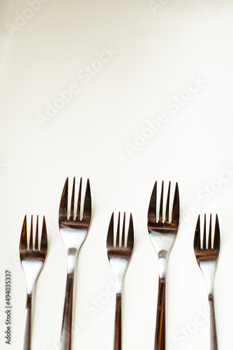 Vertical Shot of Forks on White Background