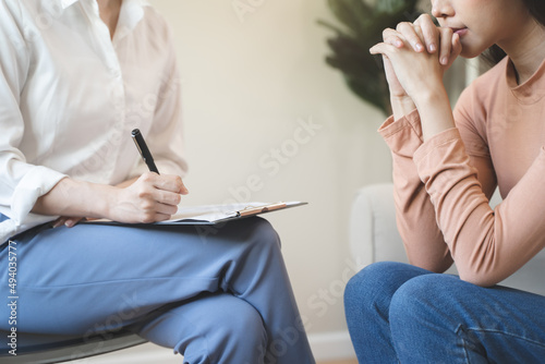 Young woman in a mental therapy session talking with a psychologist in the office. photo