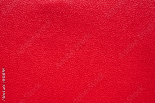 red faux leather background is used to wrap book covers or to repair everyday leather sofa seats and appliances. background and pattern on the red faux leather have space for text.