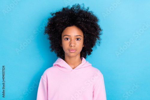 Photo of youth lovely girl intelligent focused calm wear casual clothes isolated over blue color background