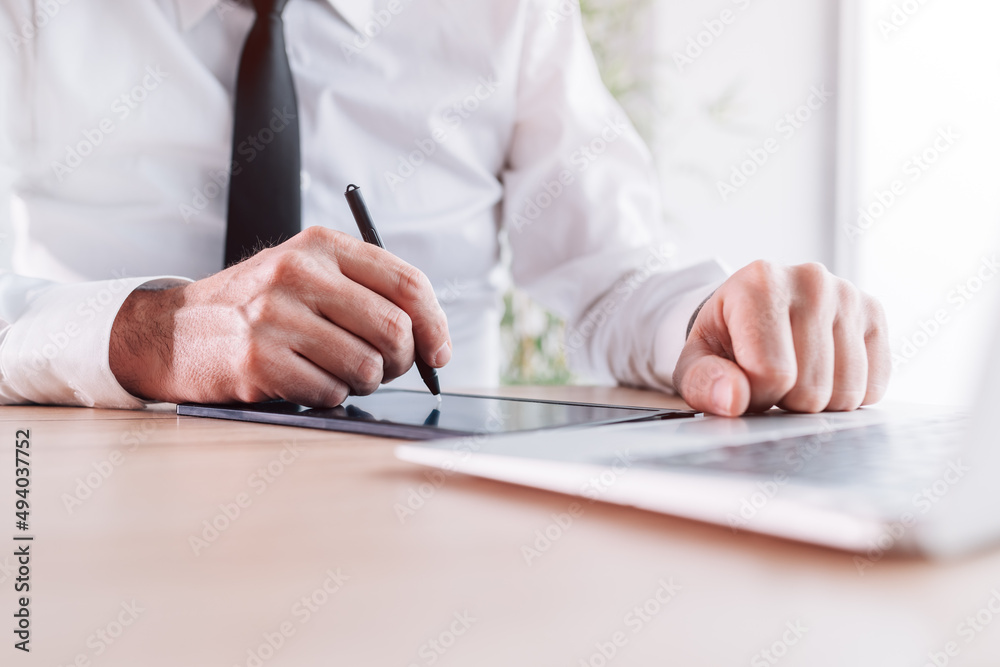 Businessman signing contract agreement with stylus pen and e-sign pad in office Businessman signing contract agreement with stylus pen and e-sign pad in office