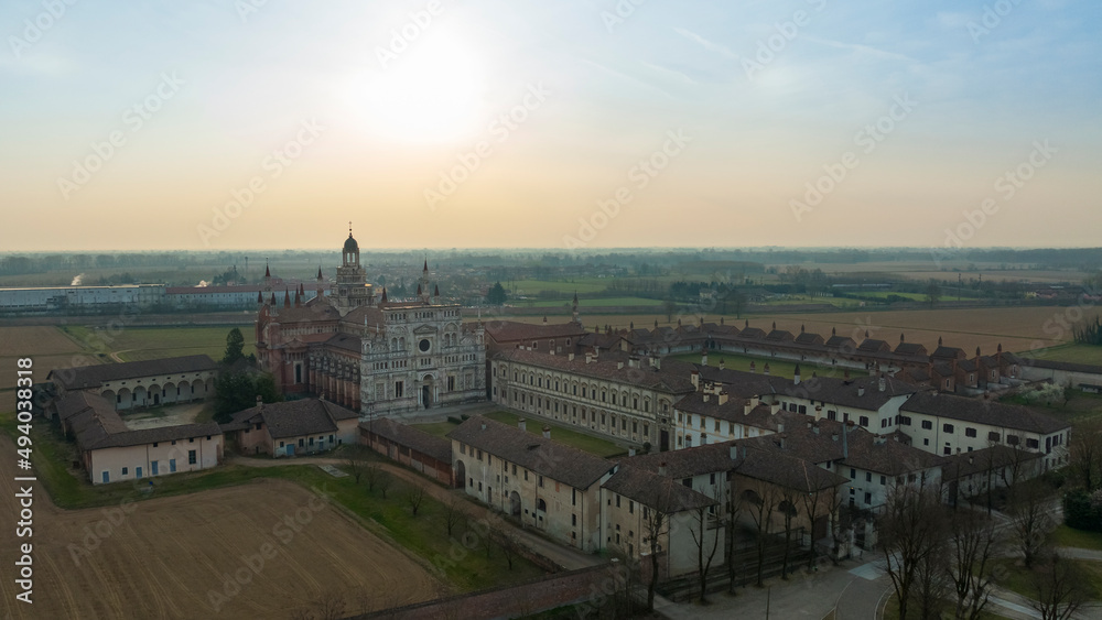 Aerial view of Certosa di Pavia a historical monumental complex that includes a monastery and a sanctuary. green court and a church, shrine in the province of Pavia, Lombardia, Italy