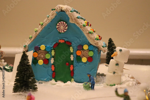 Closeup shot of a blue gingerbread house with a marshmallow snowman photo