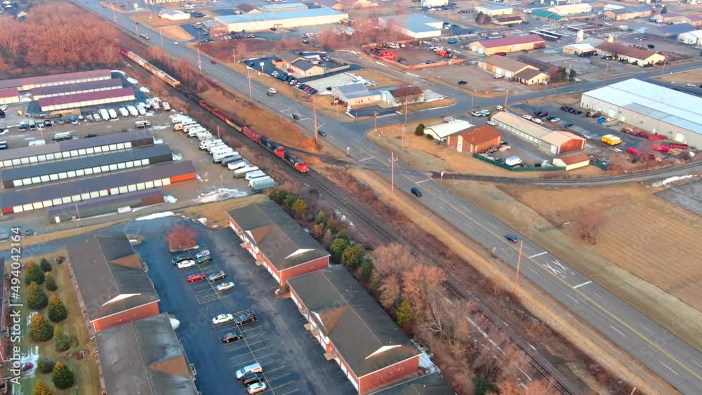 Freight train rolling past businesses in industrial zone, in Springtime
Freight train rolling past businesses in industrial zone, in Springtime