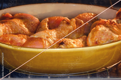 Cooking chicken leg drumstick in an oven bowl, before and after baking photo
