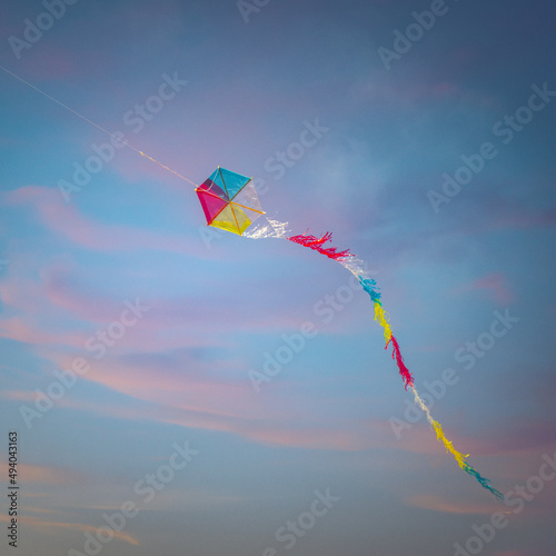 Colorful flying kite against a beautiful sunset