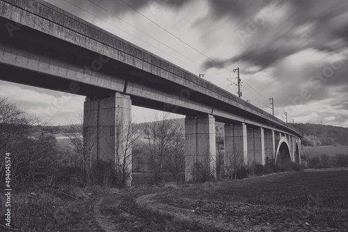 Express train bridge made of concrete with moving clouds long exposure