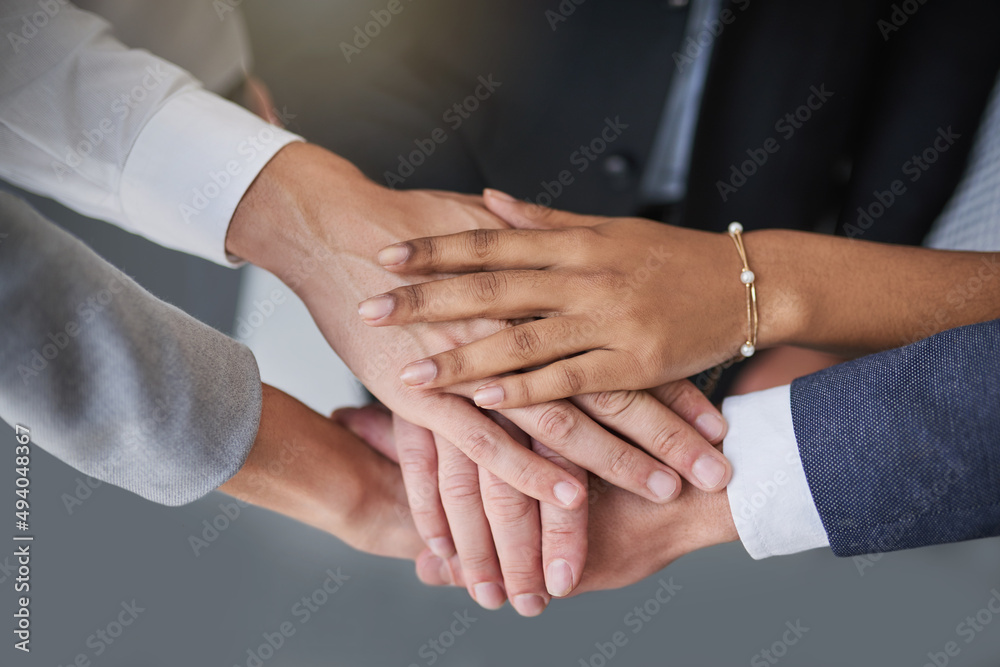 Go all in, get it done. Cropped shot of a group of colleagues joining hands in solidarity in a modern office.