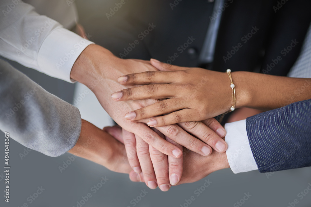 Go all in, get it done. Cropped shot of a group of colleagues joining hands in solidarity in a modern office. Go all in, get it done. Cropped shot of a group of colleagues joining hands in solidarity in a modern office.
