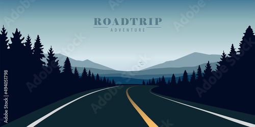 straight road in the forest on blue mountain landscape