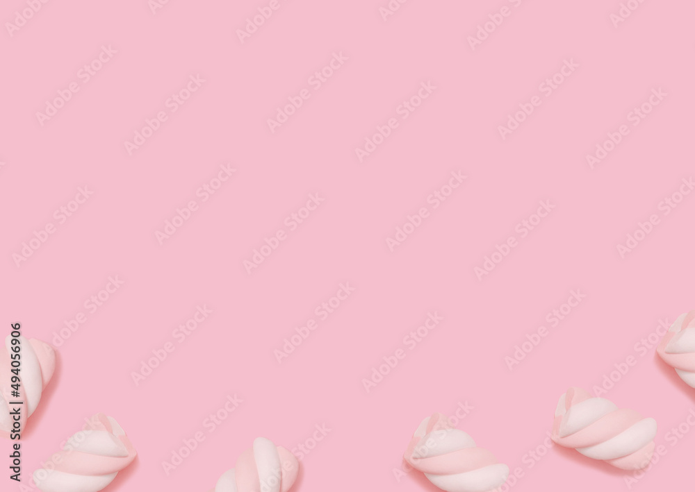Marshmallow. Top view photo. Striped two-tone bonbons on pastel pink background