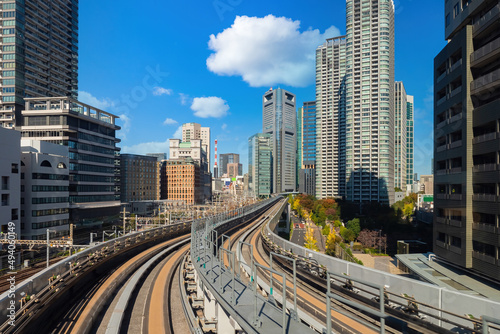 Tokyo skyline. Railroads in Japan. Modern railroads in Tokyo. Flyover between Tokyo skyscrapers. Capital of Japan in sunny weather. Downtown Japanese city. Travel Japan. Railroad on trestle