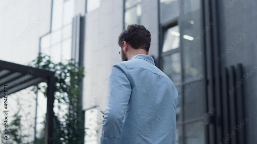 Focused ceo texting message phone at modern glass building. Businessman calling Focused ceo texting message phone at modern glass building. Businessman calling