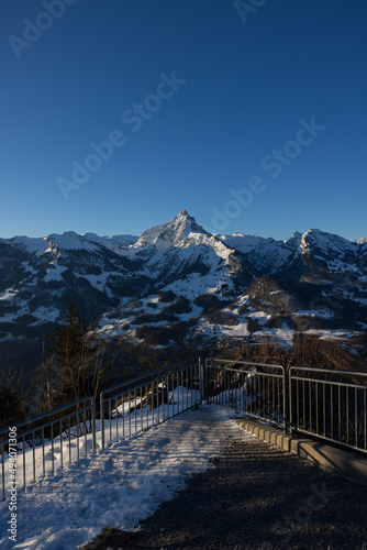 Great view on a beautiful morning over a lake called Walensee. The mountains in the background are illuminated by the morning sun.