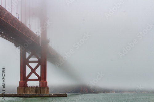 Photography Golden Gate bridge covered with heavy fog in San Francisco, California, United S