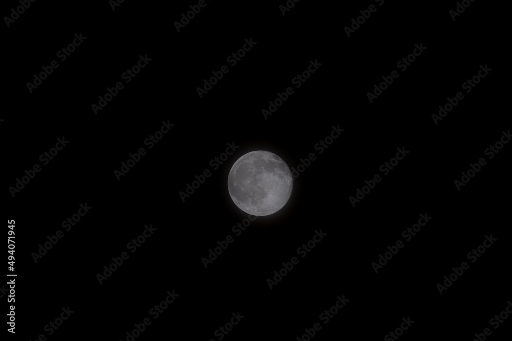 A beautiful image of a full moon illuminating the night sky. The moon is 384,400 km away from earth and yet you can see it so well. A beautiful image of a full moon illuminating the night sky. The moon is 384,400 km away from earth and yet you can see it so well.