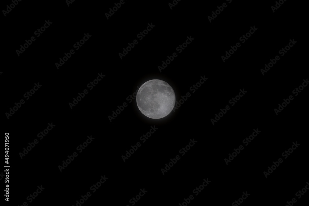 A beautiful image of a full moon illuminating the night sky. The moon is 384,400 km away from earth and yet you can see it so well. A beautiful image of a full moon illuminating the night sky. The moon is 384,400 km away from earth and yet you can see it so well.
