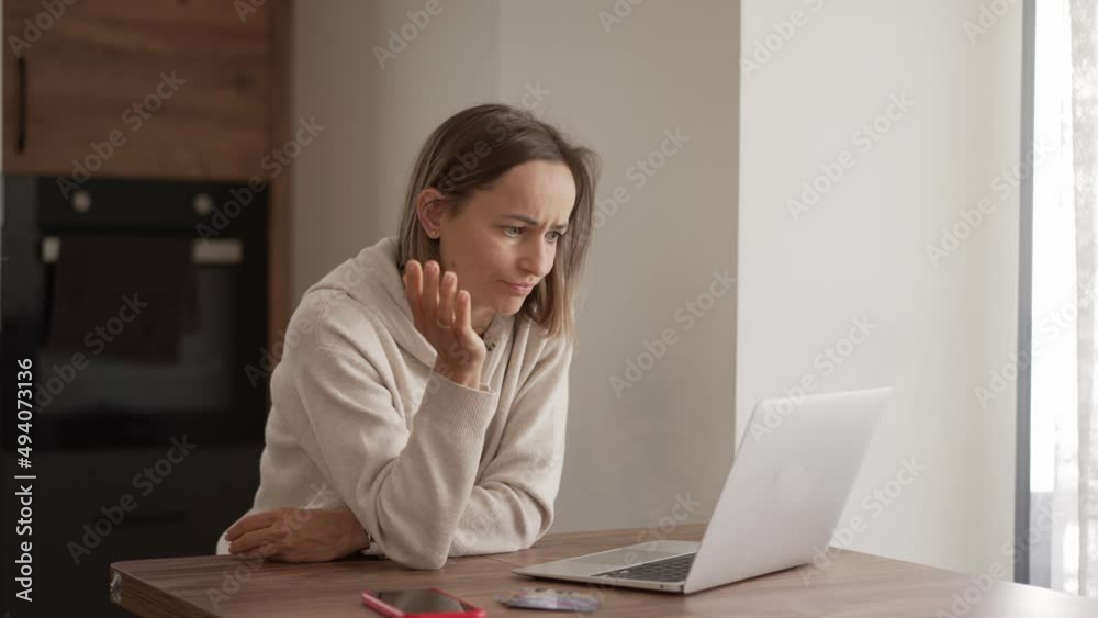 Upset young woman using online banking service, problem with blocked credit card, using laptop, irritated girl checking balance, internet fraud concept, bankruptcy or debt, overspend. Sanctions. Upset young woman using online banking service, problem with blocked credit card, using laptop, irritated girl checking balance, internet fraud concept, bankruptcy or debt, overspend. Sanctions.