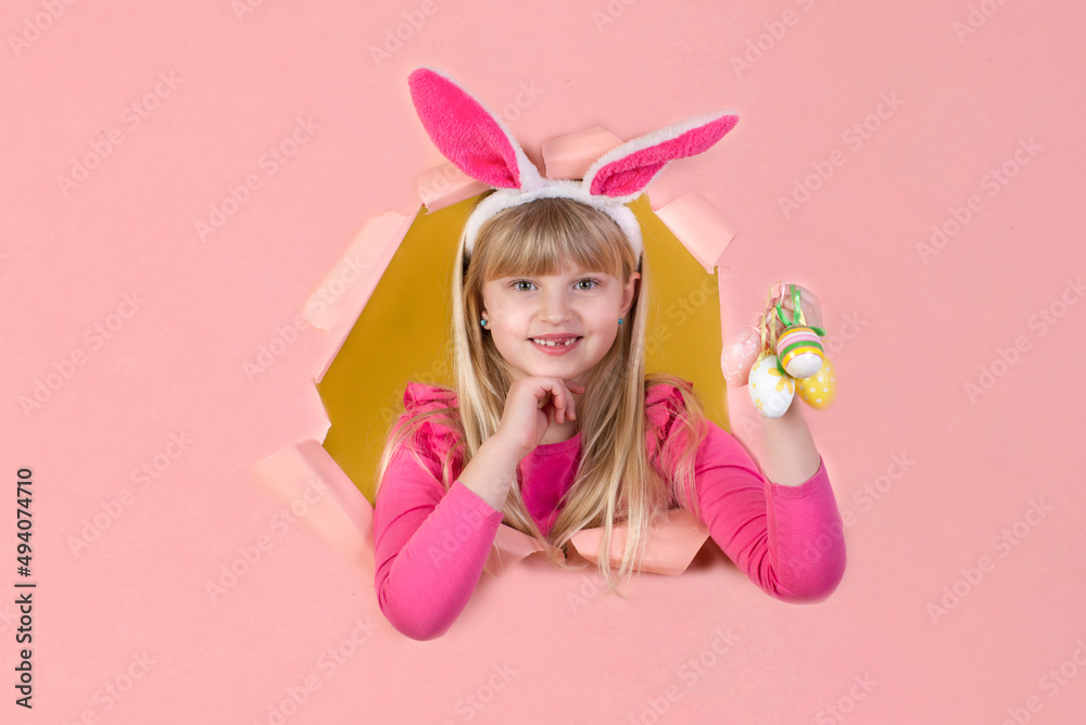 Little blonde girl for the Easter holidays with eggs