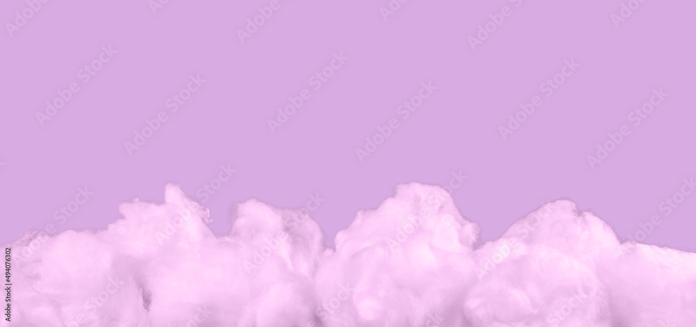 Pink cotton clouds on violet background. Monochrome surreal banner with copy space. High quality photo