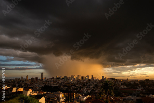 Varginha, Minas Gerais, Brazil: February 22, 2022: Torrential rain over downtown Varginha with heavy clouds at sunset